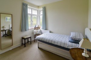 Single bed with pull out bed which can be made available if requested. Corner window and wall hung mirror