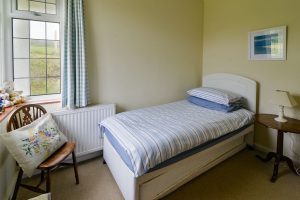 Single bed with pull out bed which can be made available if requested. Corner window and chair