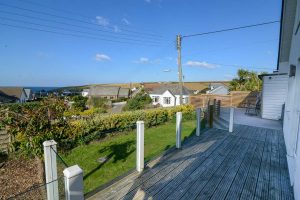 Rear garden with decking and lower level grassed area at Highview