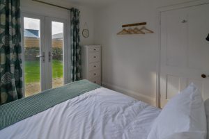 Double bedroom on the ground floor at Lowena, with patio doors leading to the back garden