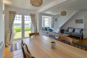 Dining area at Lowena with double doors leading into garden