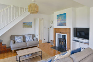 Lounge at Lowena with log burner and TV