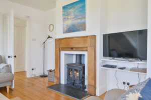 Log burner and TV in the lounge at Lowena
