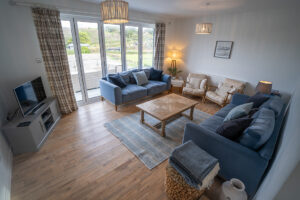 Living room with bifold patio doors at Pendarves