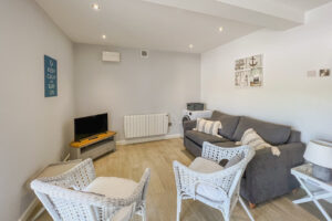 TV and seating in the garage/games room at Pendarves
