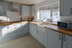 Well equipped kitchen at Pendarves with Belfast sink and integrated electric hob