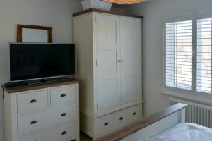 Storage and TV in Bedroom 2 at Pendarves