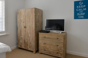 Storage and TV in twin Bedroom 4 at Pendarves