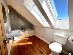Bathroom on the first floor with bath tub and over head shower at Ysella