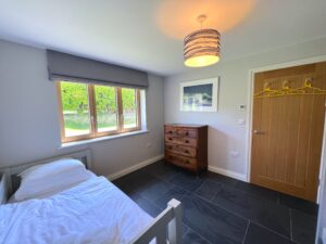 Bunk room with additional single bed on the ground floor at Ysella