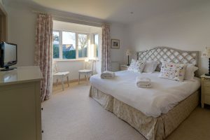 Superking bed in master bedroom at Bass Cottage