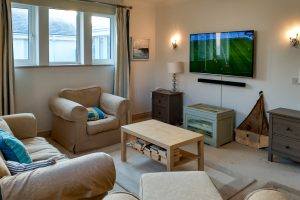 Cinema room at Bass Cottage with large mounted TV