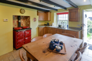 Kitchen at Treburrick Farm House with range, kitchen table stable door the front of house