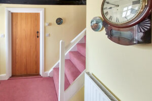 One of the two sets of stairs and doorway to dining area at Treburrick Farm House