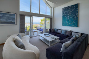 The second floor living room at Tristan with ample seating and doors to the balcony