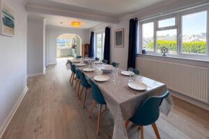 The dining room at Tristan with large dining table and chairs and window to the side of the house