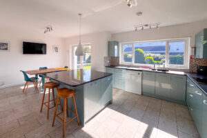 The kitchen and breakfast room at Tristan with window and door to the rear garden