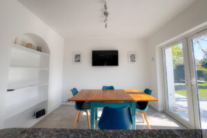 The kitchen and breakfast room at Tristan with wall mounted tv and double doors to the rear garden