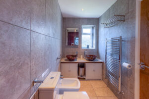 The ensuite to the master bedroom with double wash basins, toilet and bidet