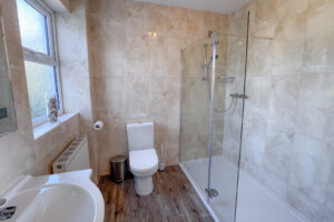 The ensuite shower room to the third king room on the first floor at Tristan with shower cubicle, toilet and wash basin