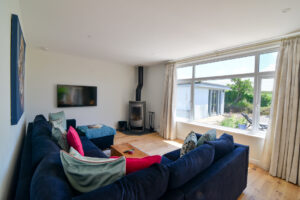 Ground floor lounge at San Marcos with log burner and mounted TV