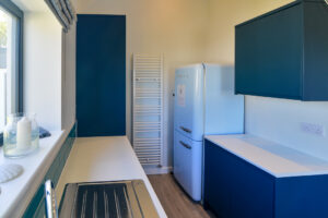 Utility room at San Marcos with additional fridge