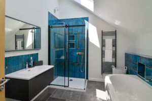 En suite bathroom from Bedroom 1 with walk in shower and separate bath tub