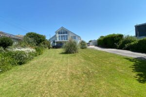 Front grassed lawn with shared driveway to the side at Tristan.