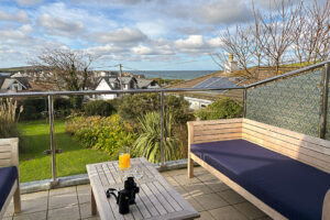 The balcony at Tristan with outside seating and views toward the ocean