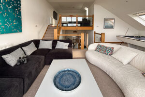 The second floor living rom at Tristan with stairs from both the first floor and stairs to the third floor living room