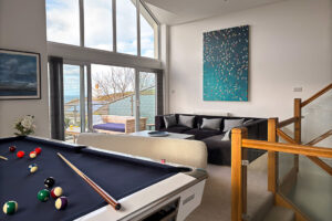 The second floor living room at Tristan featuring a pool table.