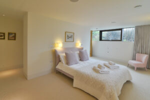 The master ensuite king bedroom on the lower ground floor at Spin with entry to the dressing room and ensuite. This room has high level windows running the length of the bedroom