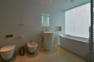 The ensuite to the master bedroom at Spin with bath, wash basin, toilet and bidet