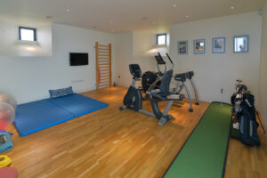 The Gym at Spin with exercise equipment and wall length mirrors