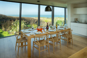 The dining table and chairs in the kitchen area at Spin with views from the large floor to ceiling windows