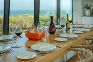 The dining table and chairs in the kitchen area at Spin with views from the large floor to ceiling windows