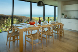 The dining table and chairs in the kitchen area at Spin with views from the large floor to ceiling windows