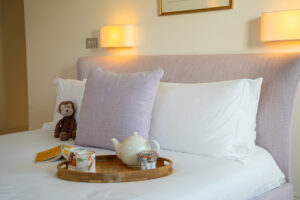 The cushion and pillows on king bed in the second lower ground floor bedroom at Spin