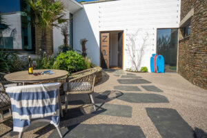 Outside courtyard at Spin with table and chairs and entrance door to the house