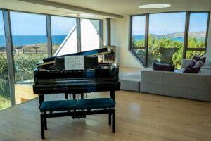 Large windows with views from the lounge area at Spin with the baby grand piano in the foreground