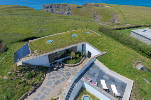 Aerial view over Spin toward the coastal footpath and the ocean
