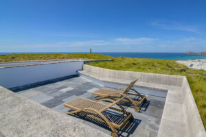 Sun loungers on the roof terrace at Spin with the ocean in the background