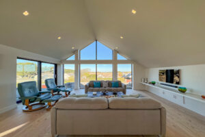 First floor lounge area with ample seating and mounted TV at Cornerstones