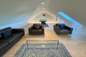 Snug room with pool table and seating on the first floor at Cornerstones