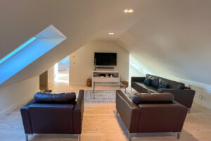 Snug room with seating and mounted TV