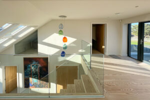 First floor stairwell to ground floor and double doors to balcony at Cornerstones