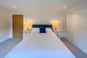 Ground floor ensuite king bedroom at Cornerstones with storage