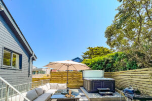 Back garden at No 1 Treglos Gardens with BBQ, seating and hot tub