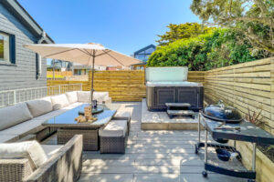 Rear decked garden at No 1 Treglos Gardens with BBQ, seating and hot tub