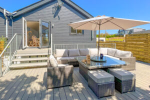 Decking to the rear of No 1 Treglos Gardens with seating and steps leading to the first floor